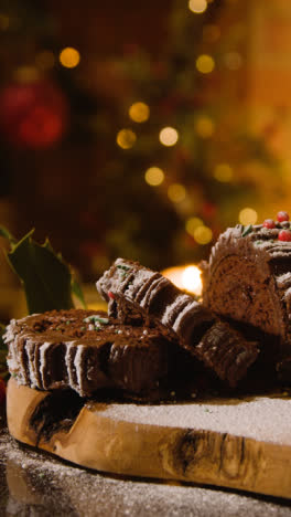 Vertical-Video-Of-At-Home-With-Food-And-Traditional-Yule-Log-Dusted-With-Icing-Sugar-Cut-Into-Slices-1